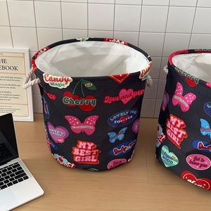 Close-up of canvas laundry hampers featuring retro heart stickers and durable rope handles