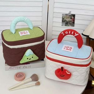 Detailed shot of quilted makeup bags with plush character charms and Jolly handles
