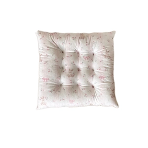 Floral square seat cushion with pink rose and rabbit patterns on soft beige fabric