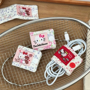 Detail of floral fabric cable organizers with cute cat embroidery and snap button closure