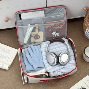Detail view of large travel organizer bag with functional compartments and red zippers