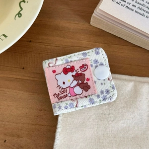Close-up of Hello Kitty floral fabric cable organizer with a white snap button