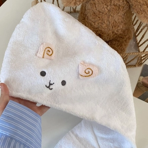 Detail of white coral fleece hair towel with cute sheep embroidery and soft plush texture