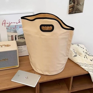 Close-up of portable folding foot bath bag in beige with reinforced black handles
