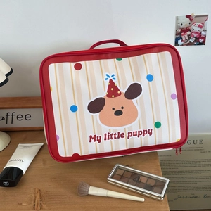 Detail of the cute cartoon puppy travel bag with red handles and smooth zipper closure