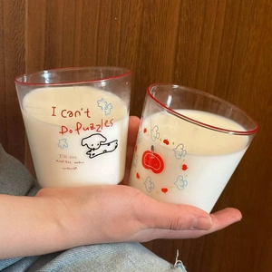 Detail of cute dog and apple pattern print on heat-resistant glass cups with red rim