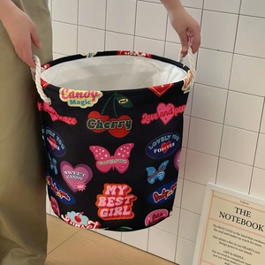 Detailed view of foldable canvas laundry basket with vintage heart prints and rope handles