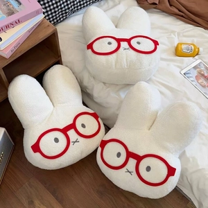 Three cute plush rabbit hot water bottle covers with red glasses on white bedding