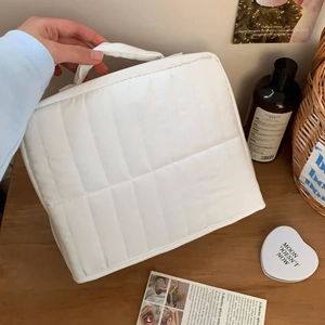Vertical quilted white makeup bag with large capacity and portable handle for travel storage