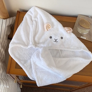 Close-up of thick coral fleece hair towel featuring cute white lamb ears and embroidery
