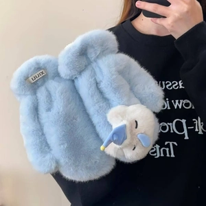 Detail of light blue plush gloves with 3D unicorn decor and soft faux fur texture