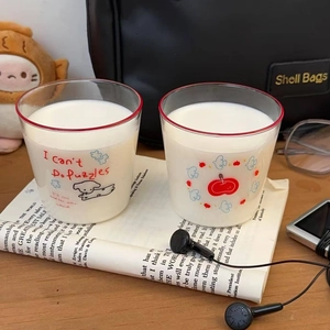 Close-up of cute cartoon dog glass cups filled with milk on a cozy lifestyle desk
