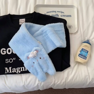 Close-up of light blue plush gloves with cute cartoon embroidery and soft white cloud detail