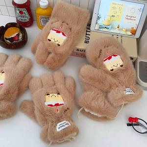 Detail of plush brown mittens with cute cake embroidery and white star beauty labels