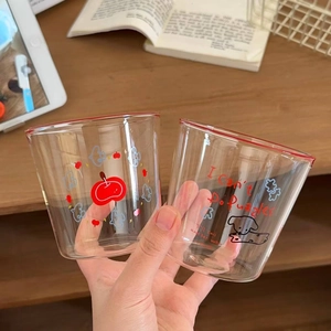 Detail of heat-resistant glass cups featuring cute puppy print and red rim accents