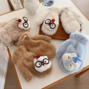 Detail of plush cartoon cat gloves in beige, apricot, brown, and blue with soft fur texture