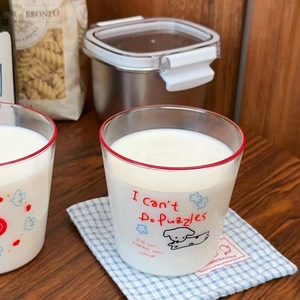 Close-up of cute cartoon dog glass cup with red rim and blue checkered coaster