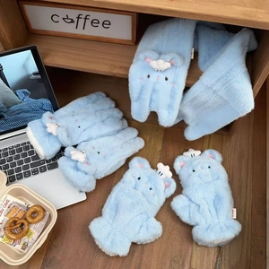 Close-up of thick sky blue plush winter scarf and gloves with cute cartoon details