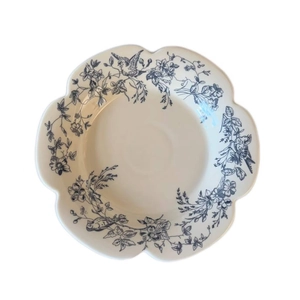 French retro blue and white ceramic plate with scalloped edges and floral bird patterns
