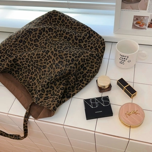 Detailed view of the leopard print tote bag interior with soft brown fabric lining