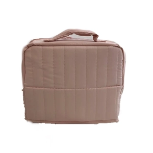 Vertical quilted dusty rose makeup bag with top handle for travel and organization