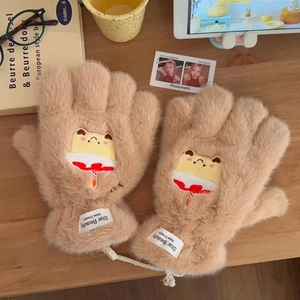 Detail of plush camel gloves with dessert embroidery and hanging rope on wooden desk