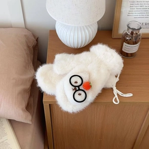 Close-up of cream fuzzy mittens featuring cute glasses decor and a soft orange pompom