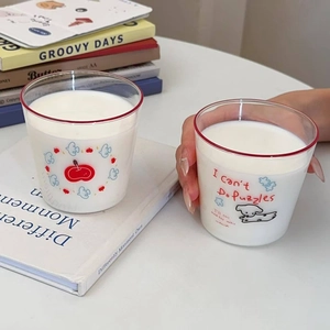 Cute cartoon puppy and apple printed heat-resistant glass milk cups in a cozy home setting