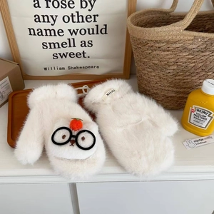 White faux fur mittens with cartoon glasses and strawberry decor in home setting