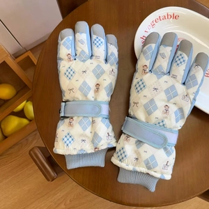 Detail of winter ski gloves showing adjustable velcro straps and knit windproof cuffs