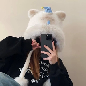 Détail du bonnet chat en peluche blanche avec mini casquette bleue et cache-oreilles à pompons