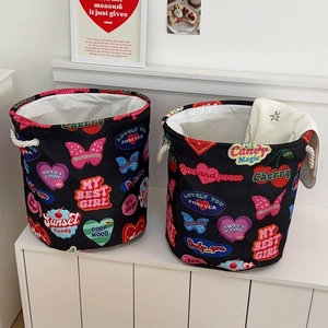 Detail view of foldable vintage laundry baskets with rope handles and heart prints