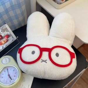 Detail of cute white plush rabbit hand warmer with red glasses and soft faux fur texture