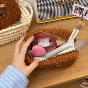 Cute teddy fleece bear makeup bag showing large interior capacity with beauty accessories