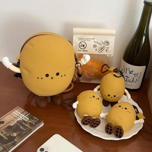 Detailed set of cute silicone potato character bags and charms on a rustic wooden table