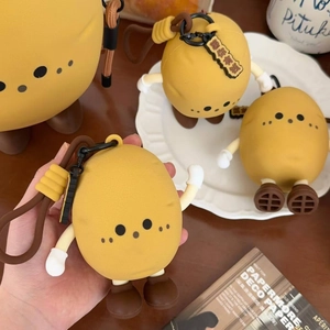 Macro detail of cute potato silicone pouch with lanyard and lucky charm tag