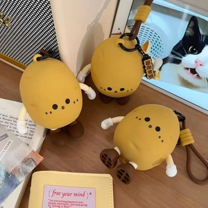 Detail of cute potato silicone mini bag with flexible limbs and lucky charm tag