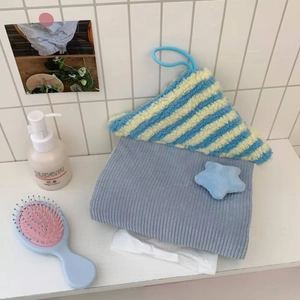Close-up of soft plush house-shaped tissue holder with blue striped fabric details