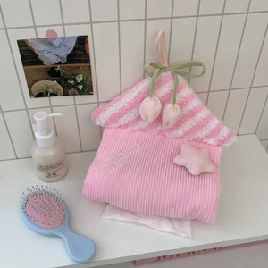 Detail of pink house-shaped tissue bag with tulip charms and soft coral fleece texture