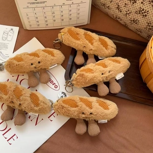 Set of five plush baguette pendants with knit legs on a cozy lifestyle background