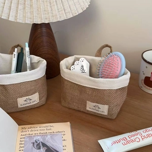 Close-up of small jute wall hanging baskets with Sleeping Cat labels for home storage