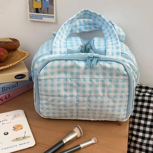 Quilted blue checkered cosmetic bag with dual handles for travel and daily storage