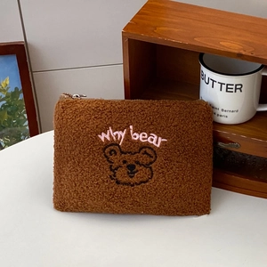 Close-up of brown Sherpa storage bag with pink Why Bear embroidery and cute bear pattern
