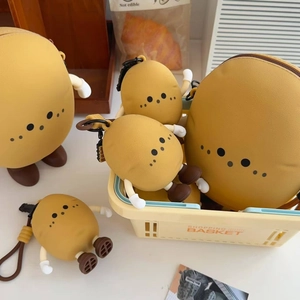 Detail of cute potato silicone coin purses and charms in a warm lifestyle setting