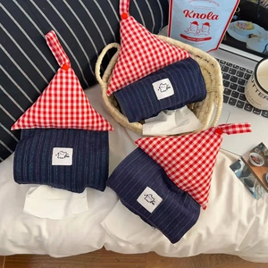 Detail of creative house-shaped tissue pouches with red gingham and navy stripe patterns