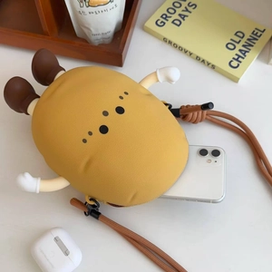 Detailed view of the cute yellow potato silicone crossbody bag with woven shoulder strap