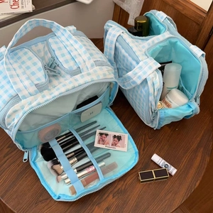 Blue gingham makeup bag detail showing internal compartments and brush slots