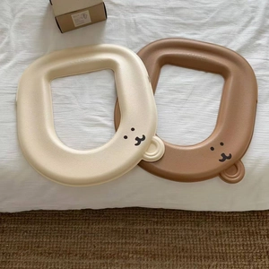 Close-up of waterproof EVA toilet seat covers with cute bear face and relief text