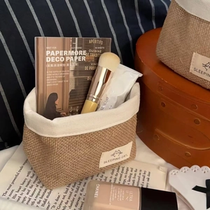 Detail of hand-woven jute storage basket with cat label used for cosmetic organization