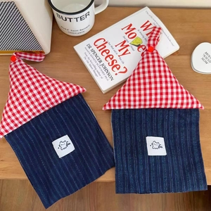Detail of red checkered house-shaped tissue holder with blue striped cat patch design